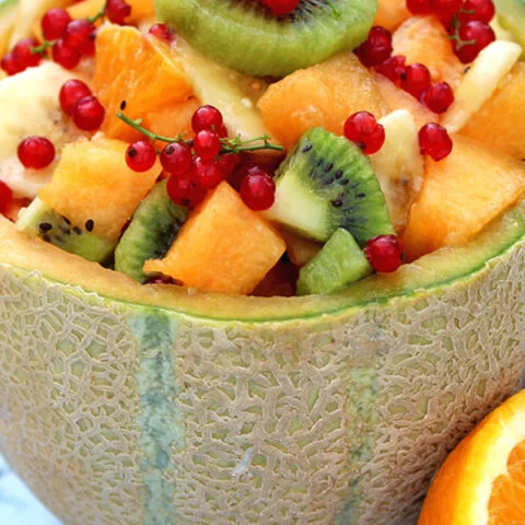 Refreshing Summer Fruit Salad enriched with melon, orange, kiwi, banana and currant. Drizzled with orange juice and honey.