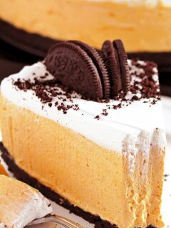 Easy No Bake Pumpkin Oreo Cheesecake so perfect for holidays and special occasions. Oreo crust, rich pumpkin cheesecake filling and whipping cream topping. Great homemade festive dessert!