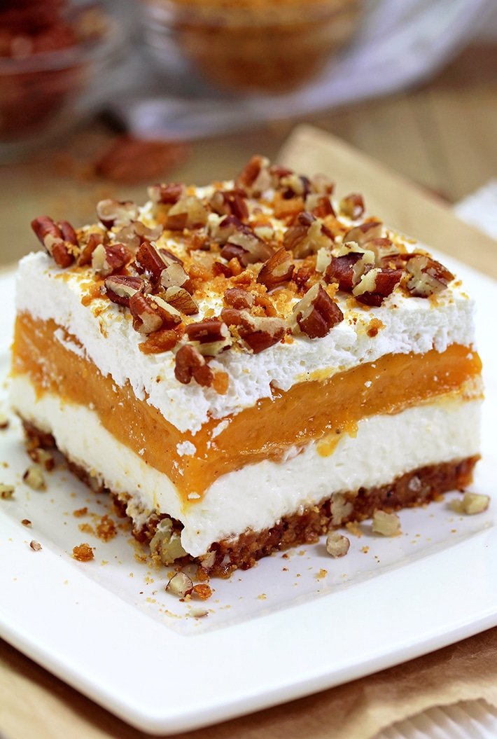 Pumpkin Lush – ce dessert crémeux rapide, léger mais délicieux, avec de la crème au fromage et des couches de citrouille, et une croûte de biscuits au gingembre, garnie de pacanes hachées et de miettes de biscuits au gingembre, ravira tous les amateurs de citrouille