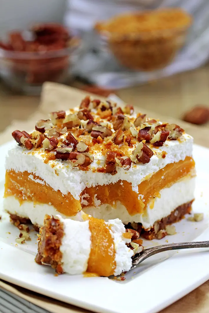Pumpkin Lush – this fast-made, light, yet delicious creamy dessert, with cheese cream and pumpkin layers, and gingersnap cookie crust, topped with chopped pecans and gingersnap cookie crumbs, will delight all the pumpkin lovers