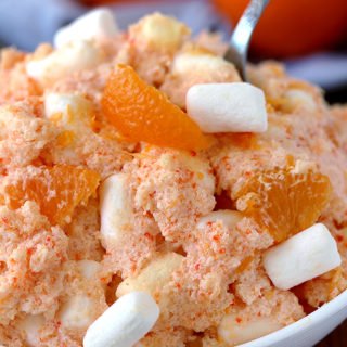 Creamsicle Orange Cheesecake Fluff Salad – this refreshing quick and easy salad is one of my favorite desserts. Cream cheese, Greek yogurt, orange juice and cool whip make this salad so creamy. Marshmallow melts in your mouth and tangerines make it refreshing.