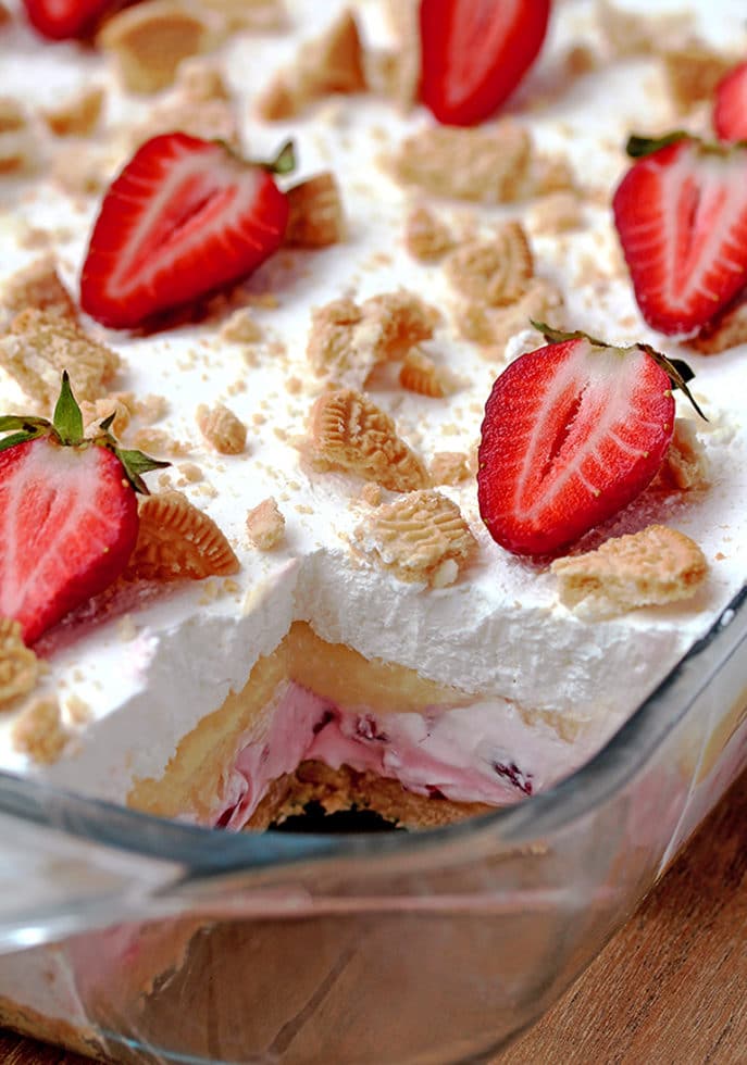 No Bake Strawberry Lush – is a layered dessert with golden Oreo crust and creamy layers of strawberry cheesecake and vanilla pudding, topped with whipped cream, crushed golden Oreos and strawberries.