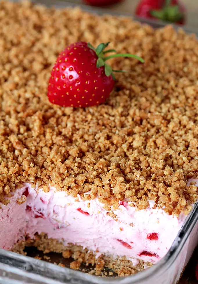 This refreshing, creamy, frozen dessert made with fresh strawberries and a crunchy graham cracker layer, topped with graham cracker crumbs is very quick and easy to prepare.