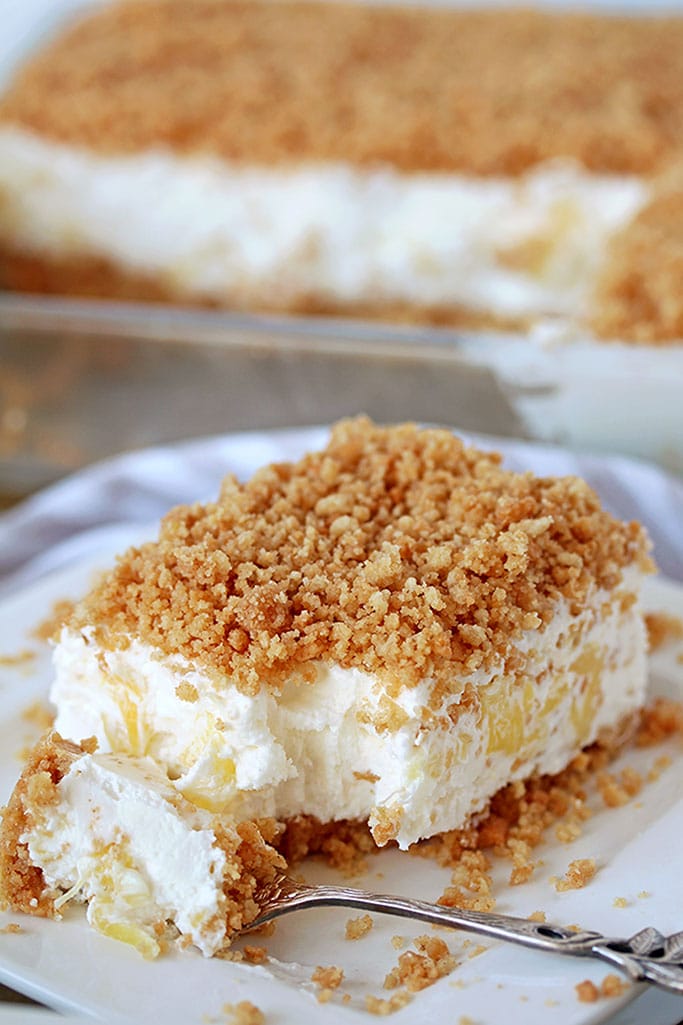 Easy Pineapple Dream Dessert a light and fluffy, quick and easy no bake creamy summer dessert. This creamy treat, made of crushed pineapple, cream cheese, butter and whipped cream and crunchy graham cracker layer, topped with graham cracker crumbs is a perfect way to sweeten hot summer days.