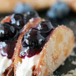 Blueberry Cheesecake Tacos – this is a recipe for very tasty dessert tacos. If you ask me, crunchy tortilla shells, filled with cheesecake filling and topped with homemade blueberry sauce make a perfect dessert.