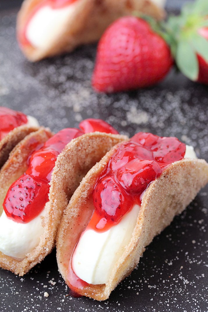 Strawberry Cheesecake Tacos – crunchy cinnamon and sugar tortilla shells, filled with cheesecake and topped with homemade strawberry sauce are perfect bites for every occasion. They are so easy to make, they look great and taste even better.