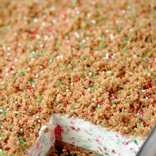 Frozen Christmas Dessert – this unique dessert has crunchy base and top and frozen, creamy filling with sprinkles in Christmas colors. A combination of filling made with cream cheese, sweetened condensed milk and whipped cream, with base and top made of graham crackers, simply has to be tried. It is so quick and easy to prepare and the taste is amazing.