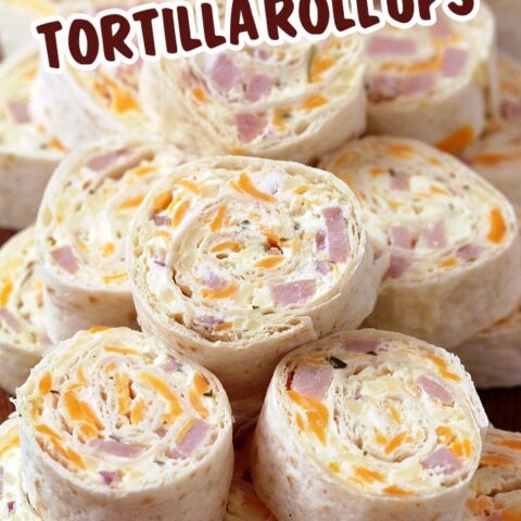 Ham and Cheese Tortilla Roll Ups are a must have party appetizer. These delicious bites are made of ham, cheddar cheese, mozzarella, cream cheese, mayo, mustard, garlic powder, onion, parsley and pepper – all rolled into a tortilla and cut into slices.
