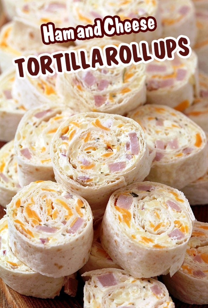 Ham and Cheese Tortilla Roll Ups are a must have party appetizer. These delicious bites are made of ham, cheddar cheese, mozzarella, cream cheese, mayo, mustard, garlic powder, onion, parsley and pepper – all rolled into a tortilla and cut into slices.