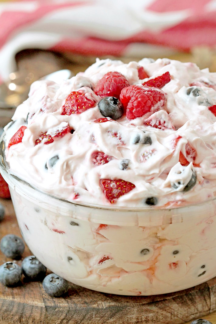 Red White and Blue Cheesecake Salad – this perfect summer salad full of fresh blueberries, strawberries and raspberries will surely sweep you off your feet. It’s quick and easy to make, refreshing and sweet at the same time. Juicy fruits combined with cheesecake filling is a winning combination. 